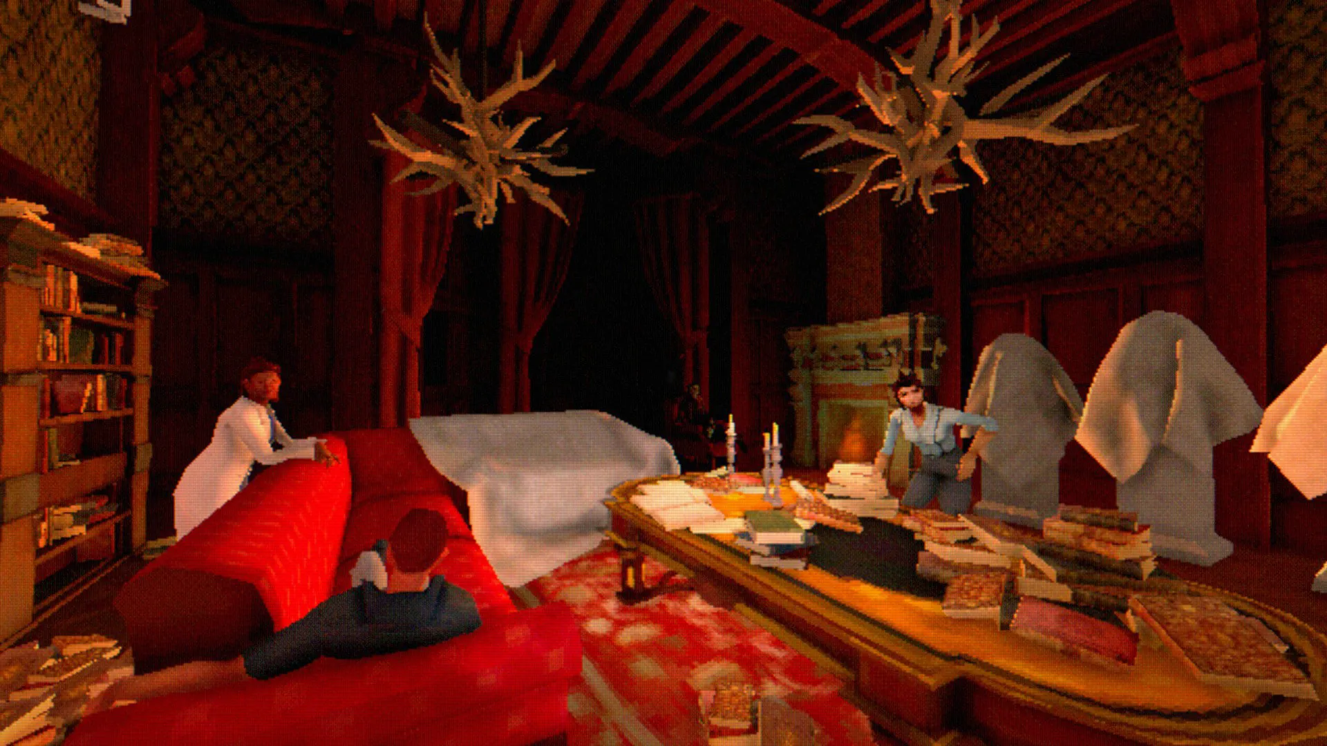 A red drawing room with antler chandeliers and dust-sheeted furniture